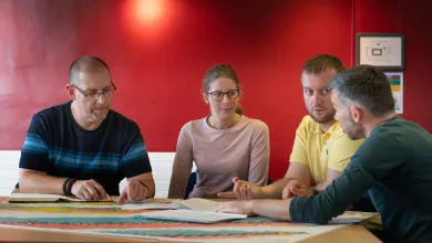 People in a meeting discussion around a table.
