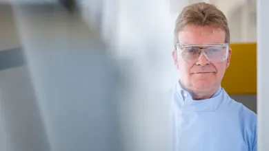 Scientist wearing safety goggles whilst working with lab equipment