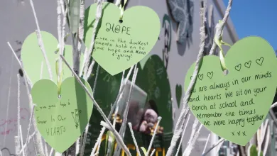 Green paper hearts with mesaages of rememberance for Grenfell Tower victims hearts with 