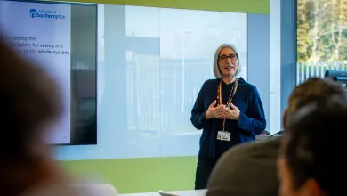 The course lead, Jeni Giambona, stood at the front of a classroom leading a session.