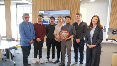 Undergraduates from the Southampton Business School standing in a line with the winners shield at the 2025 Universities Business Challenge.