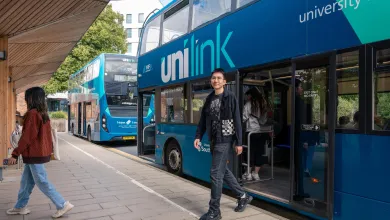 A student alighting a double decker bus at the University of Southampton's Highfield campus.