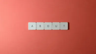 The word About on a brick-coloured background