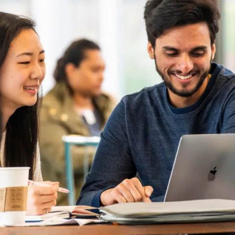 Students working together at a laptop
