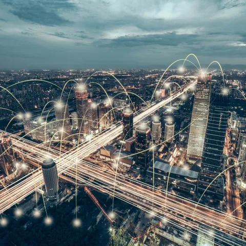 Beijing skyline at dusk with illuminated roads and buildings, overlaid with digital lines symbolizing connectivity.
