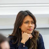 Head and shoulders portrait image of Gaby Lavenia, BA Philosophy and Politics student looking at the camera. She is resting her chin on her hand. 