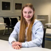 Mia Brothers sitting at a desk.