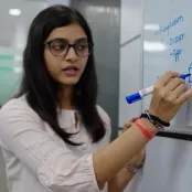 Saumya writing on a whiteboard