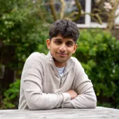 Vinay sitting outside at a table