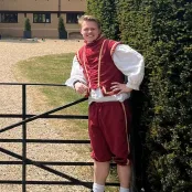 Krzysztof standing in front of Ufton Court in medieval costume