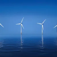 A nice calm, ocean scape of several wind farms