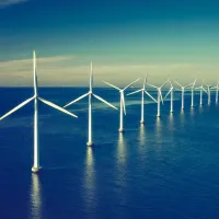 Offshore wind turbines in coastal waters, representing sustainable and resilient ocean engineering solutions