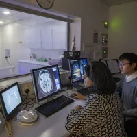 Researchers Angela and Kai review the resulults of an MRI brainscan