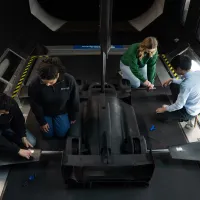 Researchers working on a model racing car in the University of Southampton's wind tunnel facility
